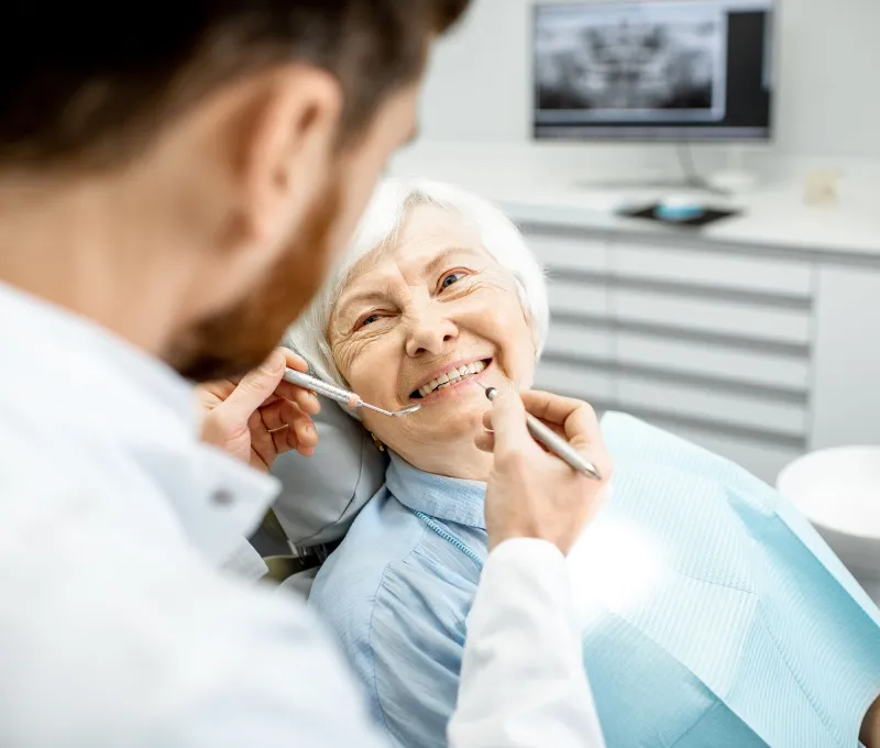 Dentist checking the teeth of a senior woman