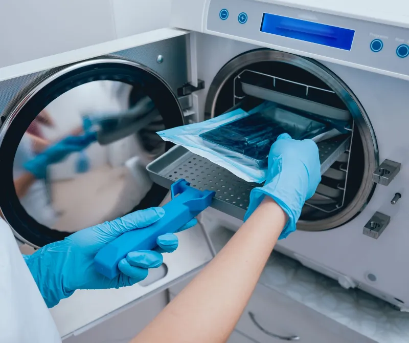 Sterilizing medical instruments in autoclave.