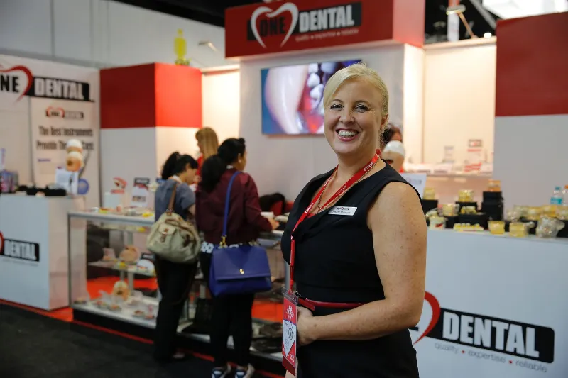 Woman happily looking at the camera in an expo