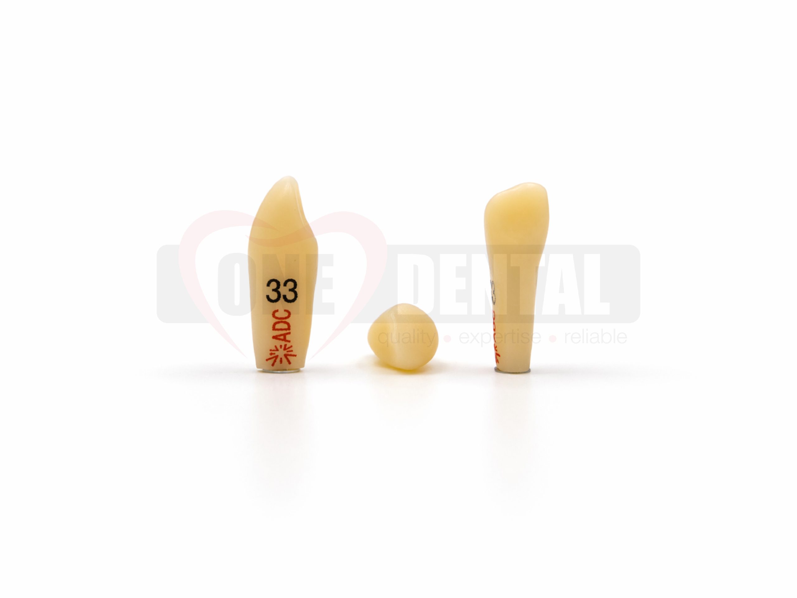 WPADC33.jpg Three beige silicone testicular implants of different sizes standing upright on a white surface, with red measurement markings visible on one implant.